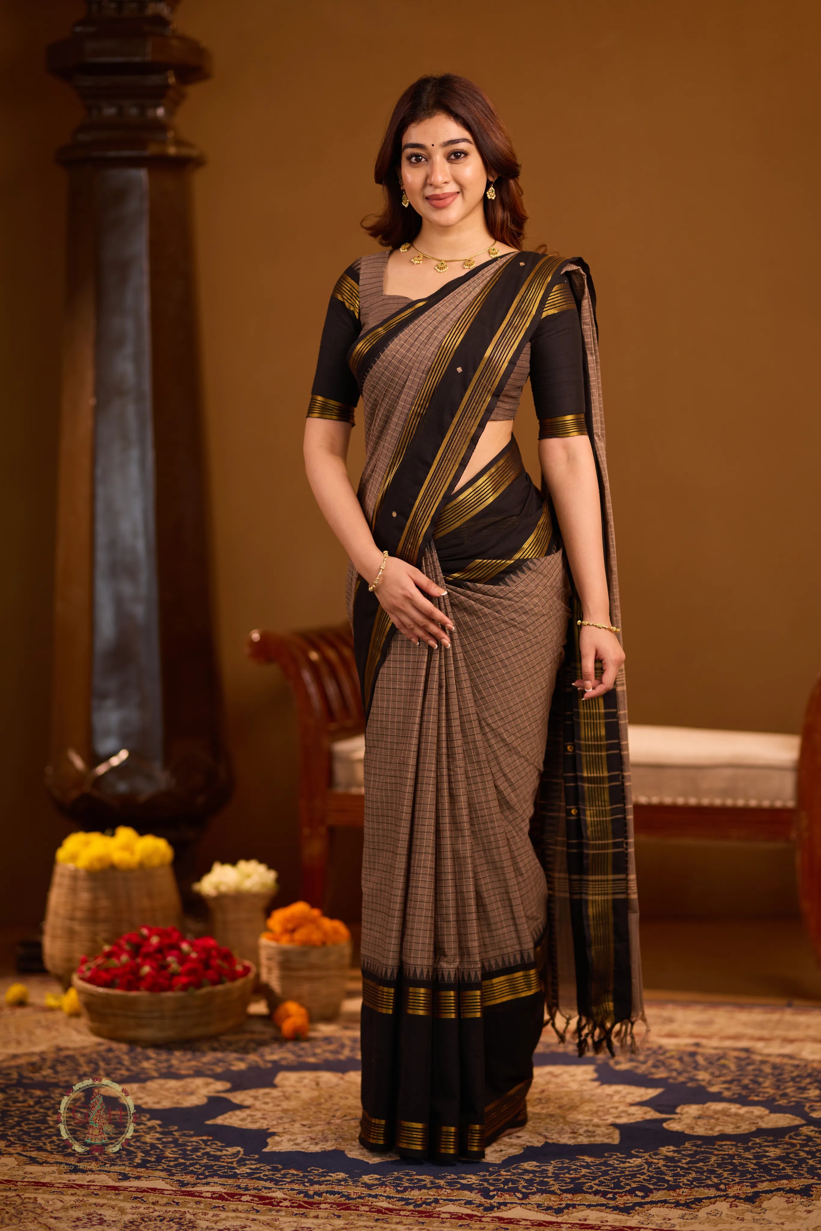 Warm brown with black border and golden zari detailing